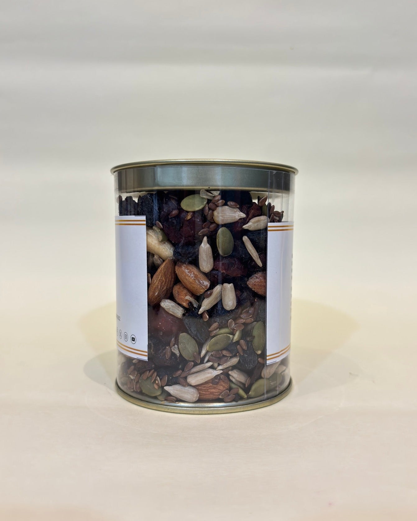 Canister of mixed seeds on a white background