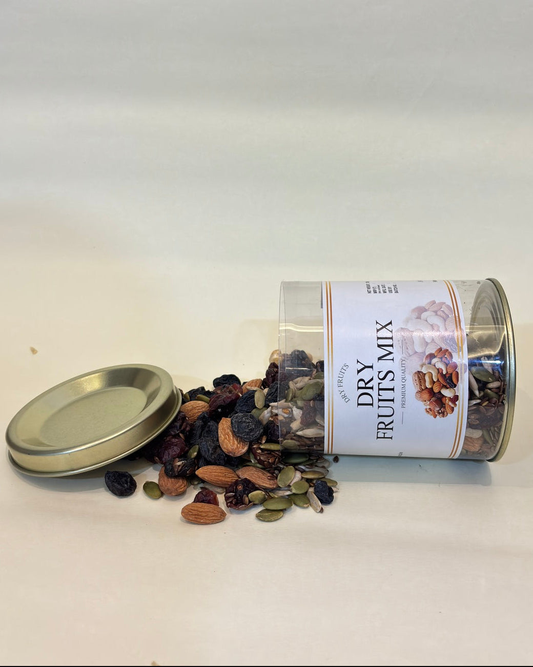 Canister of dry fruit mix with a label on a white background